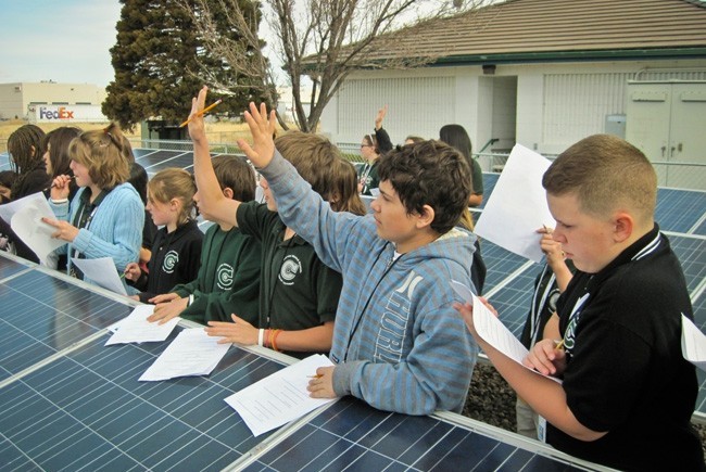 A group of students at a solar panel field trip
